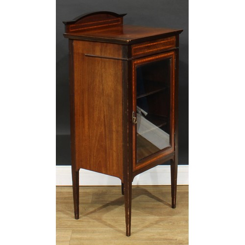 582 - An Edwardian satinwood banded mahogany music room cabinet, rectangular top with shaped half-gallery ... 