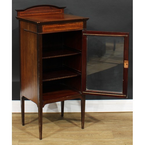 582 - An Edwardian satinwood banded mahogany music room cabinet, rectangular top with shaped half-gallery ... 