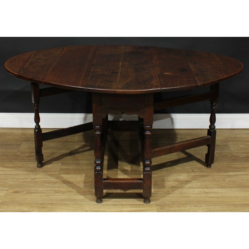 587 - A late 18th century oak gateleg table, 69cm high, 42cm opening to 143.5cm long, 110cm wide; an early... 