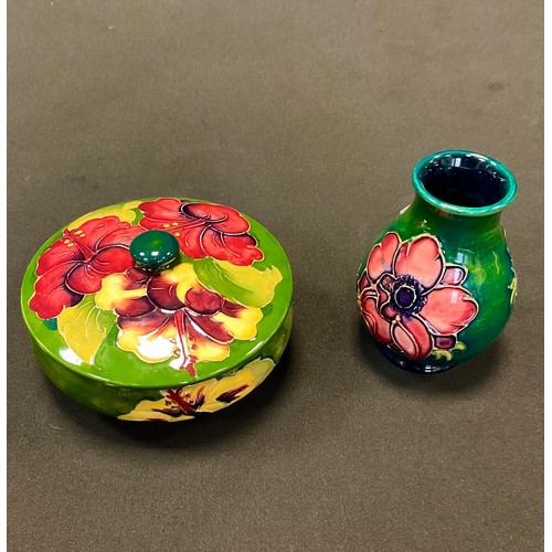 48 - A Moorcroft Hibiscus pattern trinket pot and cover, tube lined with large flowerheads in tones of re... 