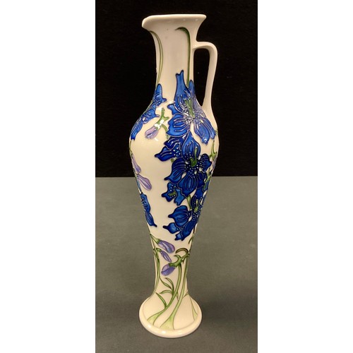 47 - A contemporary Moorcroft jug, tube lined with blue flowers and sinuous foliage on an ivory ground, 3... 