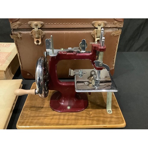 190A - Sewing and Needlework - a miniature table top sewing machine, cased; a quantity of buttons; etc