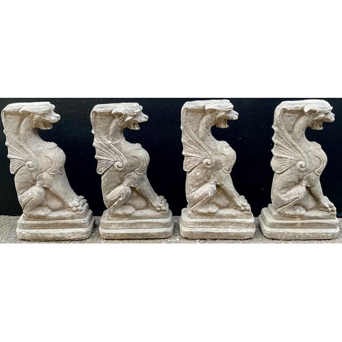 3030 - A set of four composition architectural caryatids, each modelled as a griffin, 49cm high


**Please ... 