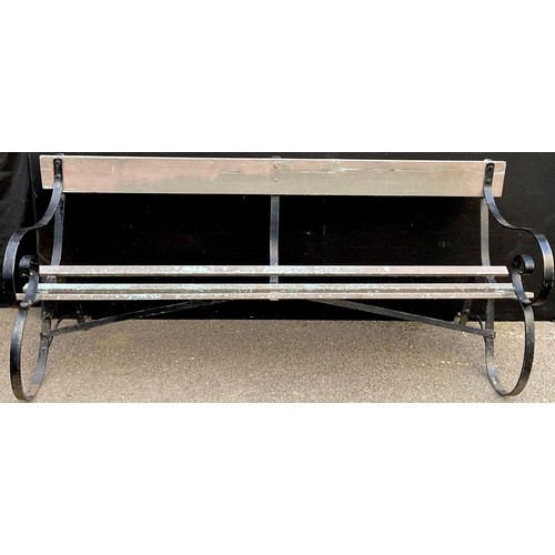 3045 - An early 20th century garden bench, wrought iron scroll end supports

**Please note that some of the... 