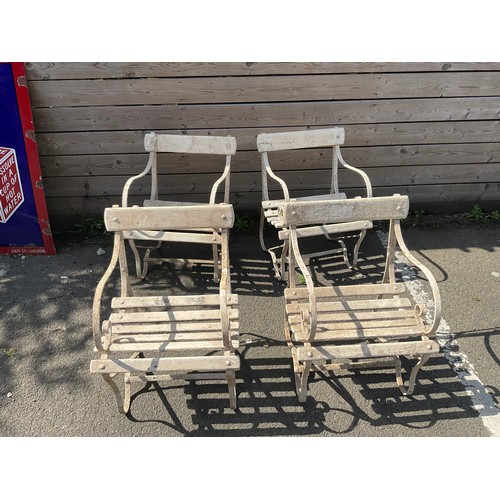 3089 - A set of four Edwardian wrought iron scroll arm garden chairs, wooden bar slats, in creamy white, 74... 