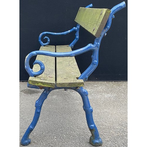 3127 - A cast iron and wood garden bench, branch effect scroll arms, now painted blue length 145.5cm height... 