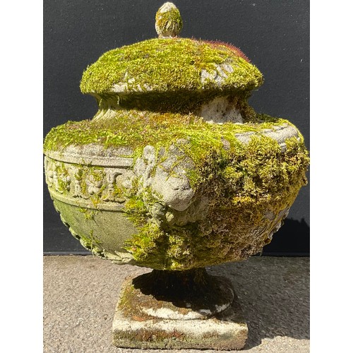 3128 - A composite garden urn, moulded with swags, lion heads to sides, square base


**Please note that so... 