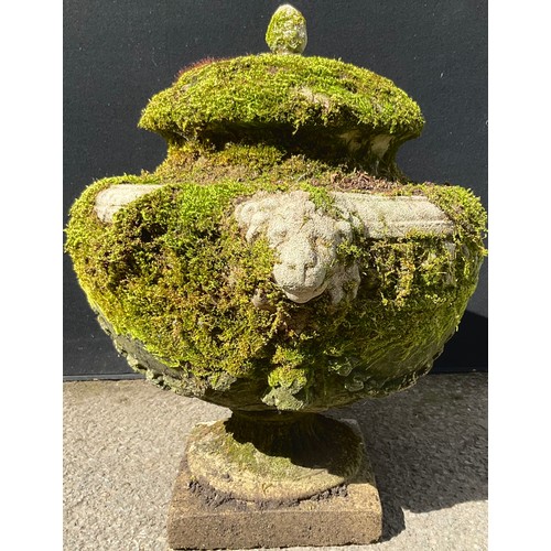 3128 - A composite garden urn, moulded with swags, lion heads to sides, square base


**Please note that so... 