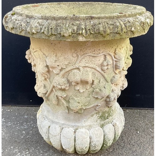 3136 - A composite garden urn, moulded with grapes and vine, fluted base width 57cm height 60cm



**Please... 