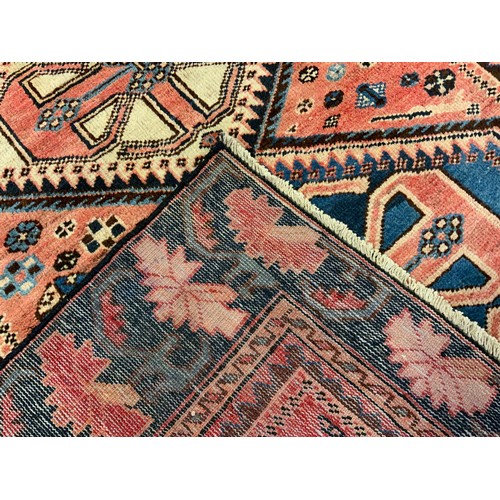 41 - A central Persian Bakhtiar rug / carpet, knotted in tones of pale red, blue, cream, and deep blue, w... 