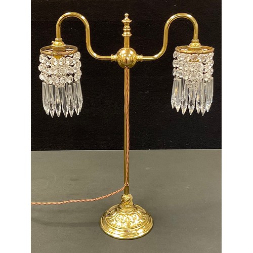 60 - A late 19th/early 20th century style brass table lamp, two arm arched lights each with cut glass dro... 