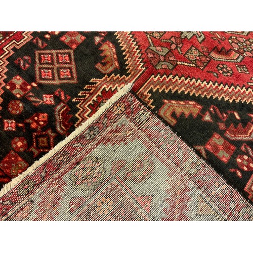 99 - A North-West Persian Zanjan rug / carpet, knotted in tones of deep red, black, and pale grey, 232cm ... 