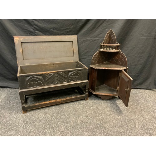 103 - An early 20th century Gothic revival carved oak wall hanging cornet cabinet, open galleried top abov... 