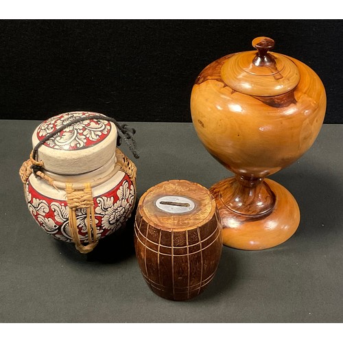 157 - A Barrel money box;  Olive wood covered tea caddy urn; painted coconut and basket weave canister/tea... 