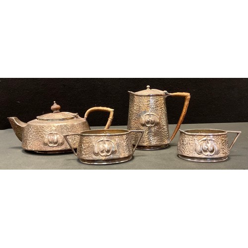 159 - An Arts and Crafts pewter four piece tea set, hammered and embossed body with Archibald Knox style r... 