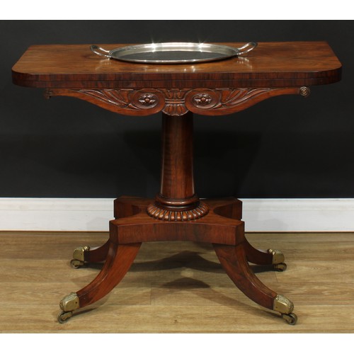 1776 - A Regency rosewood tea table, hinged top above a deep frieze carved with scrolling lotus and bosses,... 