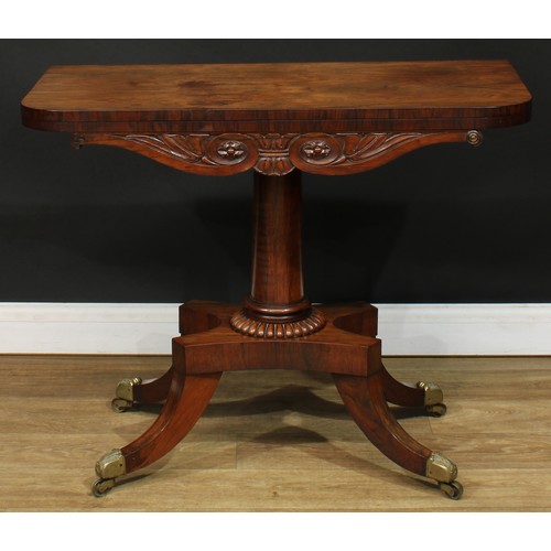 1776 - A Regency rosewood tea table, hinged top above a deep frieze carved with scrolling lotus and bosses,... 