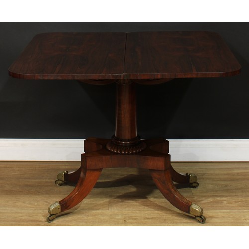 1776 - A Regency rosewood tea table, hinged top above a deep frieze carved with scrolling lotus and bosses,... 