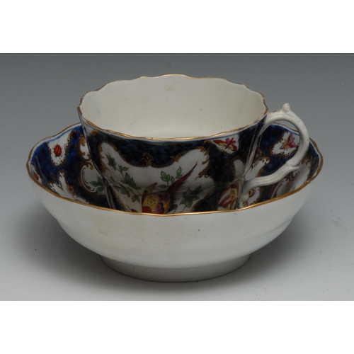 672 - A Worcester Trembluese  cup and saucer, painted in the manner of Giles with fanciful birds on a scal... 