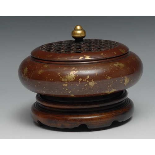 907 - A Chinese bronze compressed circular censor, gold flecks, pierced cover, gilt finial, 13.5cm high, s... 