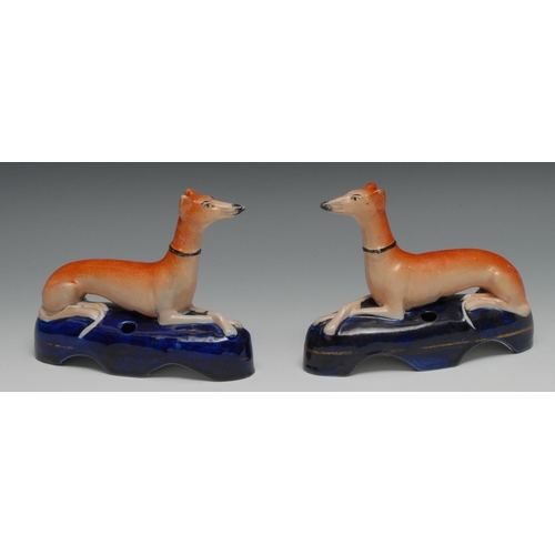 677 - A pair of Staffordshire greyhound pen rests, tan coat markings, the cobalt blue gilt lined bases wit... 