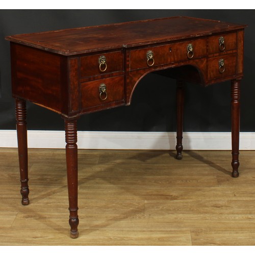 1766 - A Regency mahogany serving table, slight breakfront top with reeded edge above an arrangement of fou... 