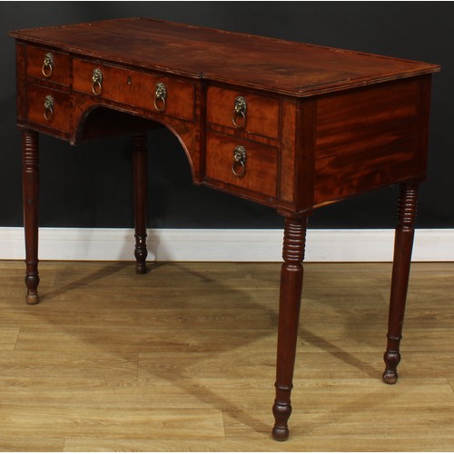 1766 - A Regency mahogany serving table, slight breakfront top with reeded edge above an arrangement of fou... 