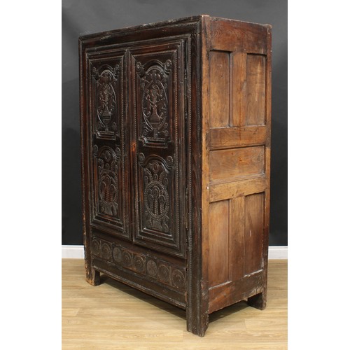 1649 - A late 17th century oak livery cupboard or housekeeper's cupboard, flush stiled frame centred by a p... 