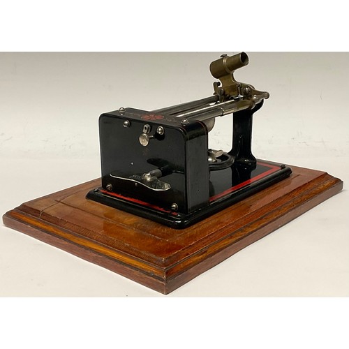 1327 - An early 20th century Excelsior EWC phonograph, in black, outlined in red, 30cm wide