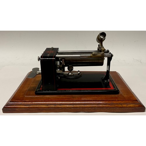 1327 - An early 20th century Excelsior EWC phonograph, in black, outlined in red, 30cm wide