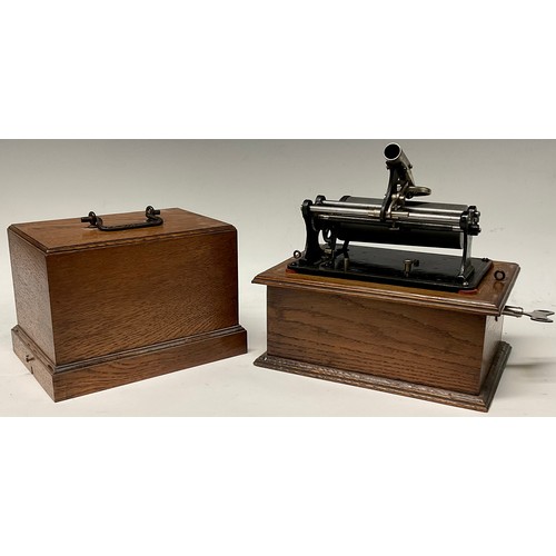 1331 - An early 20th century phonograph, in black, oak case, 22cm wide