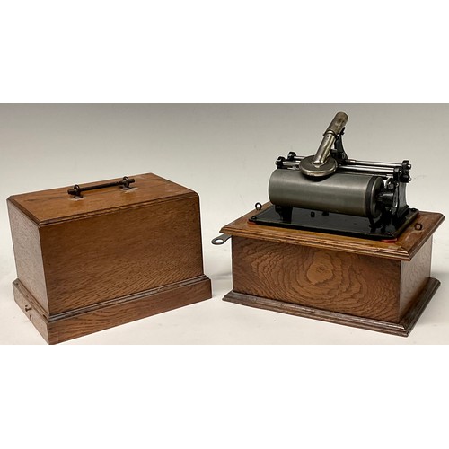 1331 - An early 20th century phonograph, in black, oak case, 22cm wide