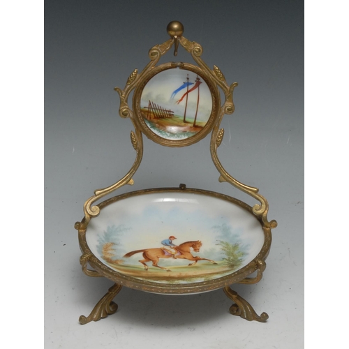 1266 - A French gilt metal and porcelain pocket watch stand, decorated in polychrome with a racehorse, 17cm... 