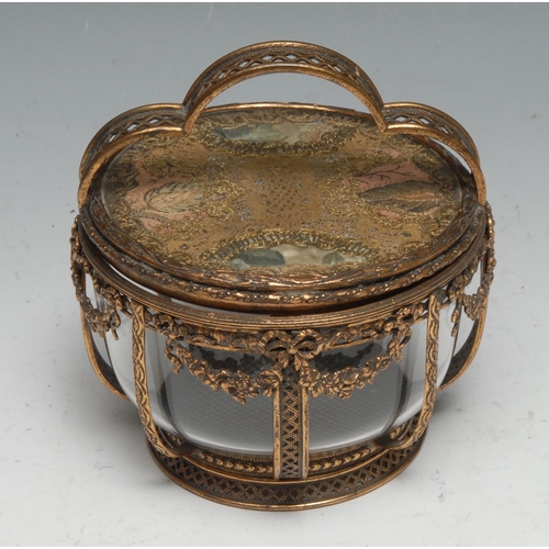 1269 - A French gilt metal circular dressing table box,  shaped handle, the glazed lid set with lace and si... 