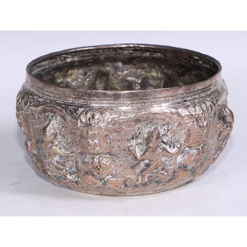 86 - A Burmese silver coloured metal bowl, repousse chased with nat sein, 16.5cm diam, marked to base, 35... 