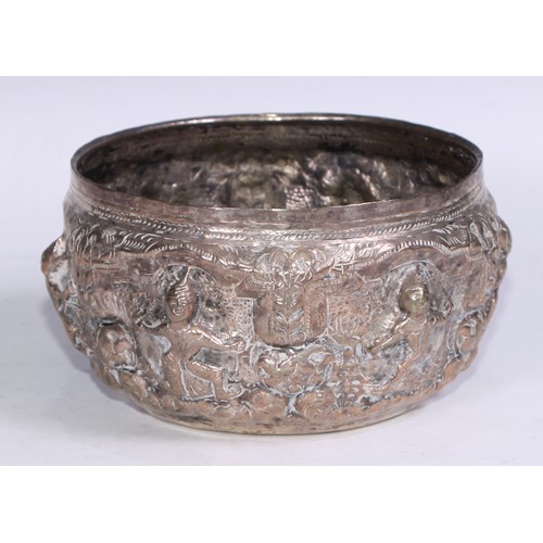 86 - A Burmese silver coloured metal bowl, repousse chased with nat sein, 16.5cm diam, marked to base, 35... 