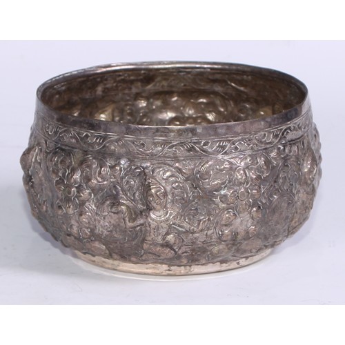 86 - A Burmese silver coloured metal bowl, repousse chased with nat sein, 16.5cm diam, marked to base, 35... 