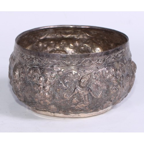 86 - A Burmese silver coloured metal bowl, repousse chased with nat sein, 16.5cm diam, marked to base, 35... 