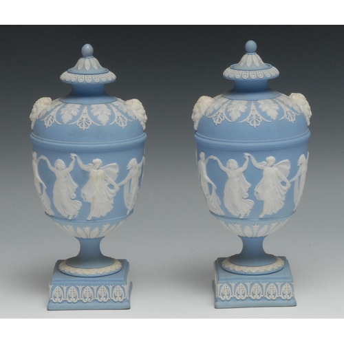 554 - A pair of 19th century Wedgwood Jasperware pedestal vases and covers, typically sprigged in white wi... 