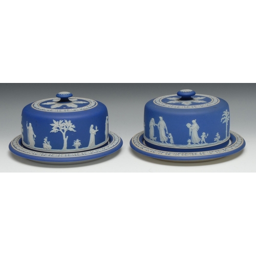 549 - A near pair of 20th century Wedgwood Jasperware cheese domes and stands, typically sprigged with cla... 