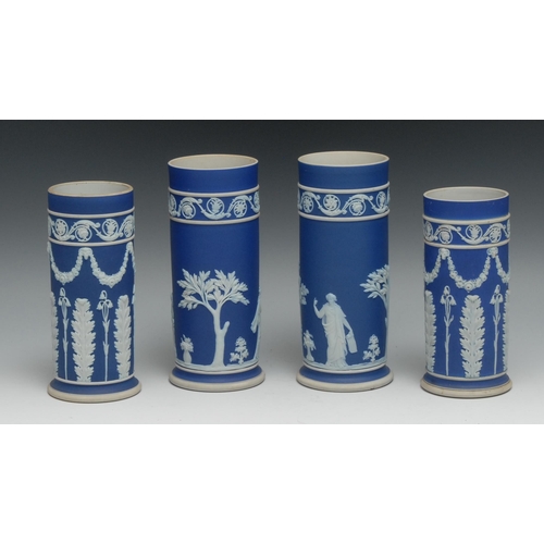 551 - A pair of 19th century Wedgwood Jasperware cylindrical vases, typically sprigged with classical scen... 