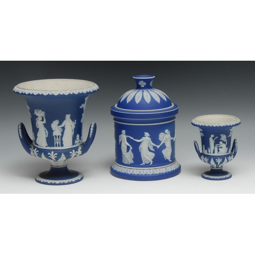 545 - A 19th century Wedgwood Jasperware jar and cover, typically sprigged with classical scenes on a dark... 