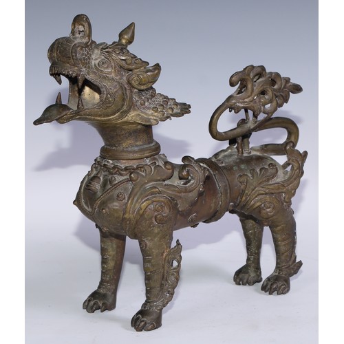 A Chinese bronze kylin, standing four square and ferocious, 32cm long ...