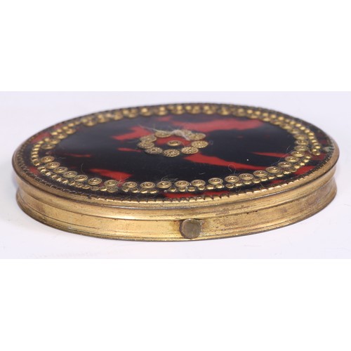 1294 - An 18th century tortoiseshell and gilt metal oval snuff box, hinged cover decorated with pique round... 