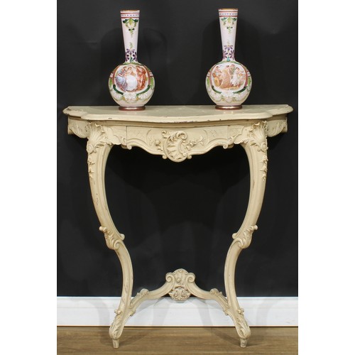 1778 - A Rococo Revival painted console table, oversailing serpentine top above a frieze drawer, carved wit... 