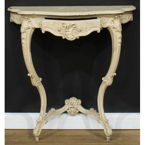 1778 - A Rococo Revival painted console table, oversailing serpentine top above a frieze drawer, carved wit... 