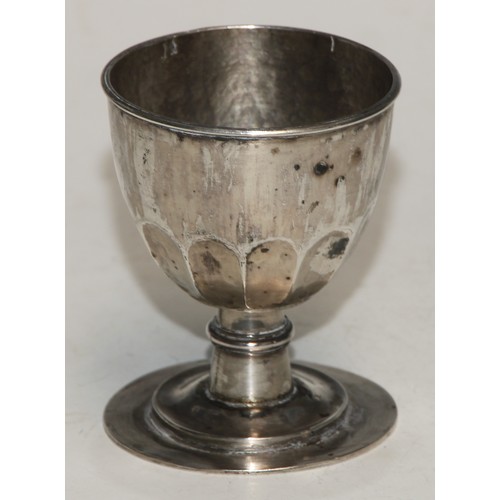 22 - An 18th century half-fluted chalice, ring-knop to stem, stepped circular foot, 8cm high