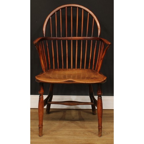 1652 - A late 18th century yew and elm Windsor elbow chair, slightly pointed low hoop back, curved arm rail... 