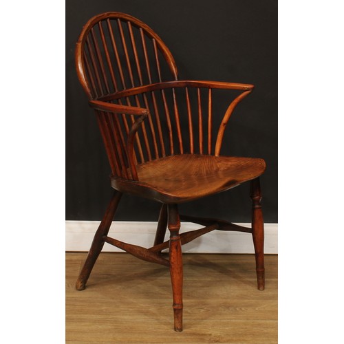 1652 - A late 18th century yew and elm Windsor elbow chair, slightly pointed low hoop back, curved arm rail... 