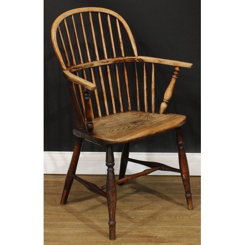 1404 - A 19th century beech and elm stick back Windsor elbow chair, hoop back, one-piece mid-rail, turned a... 